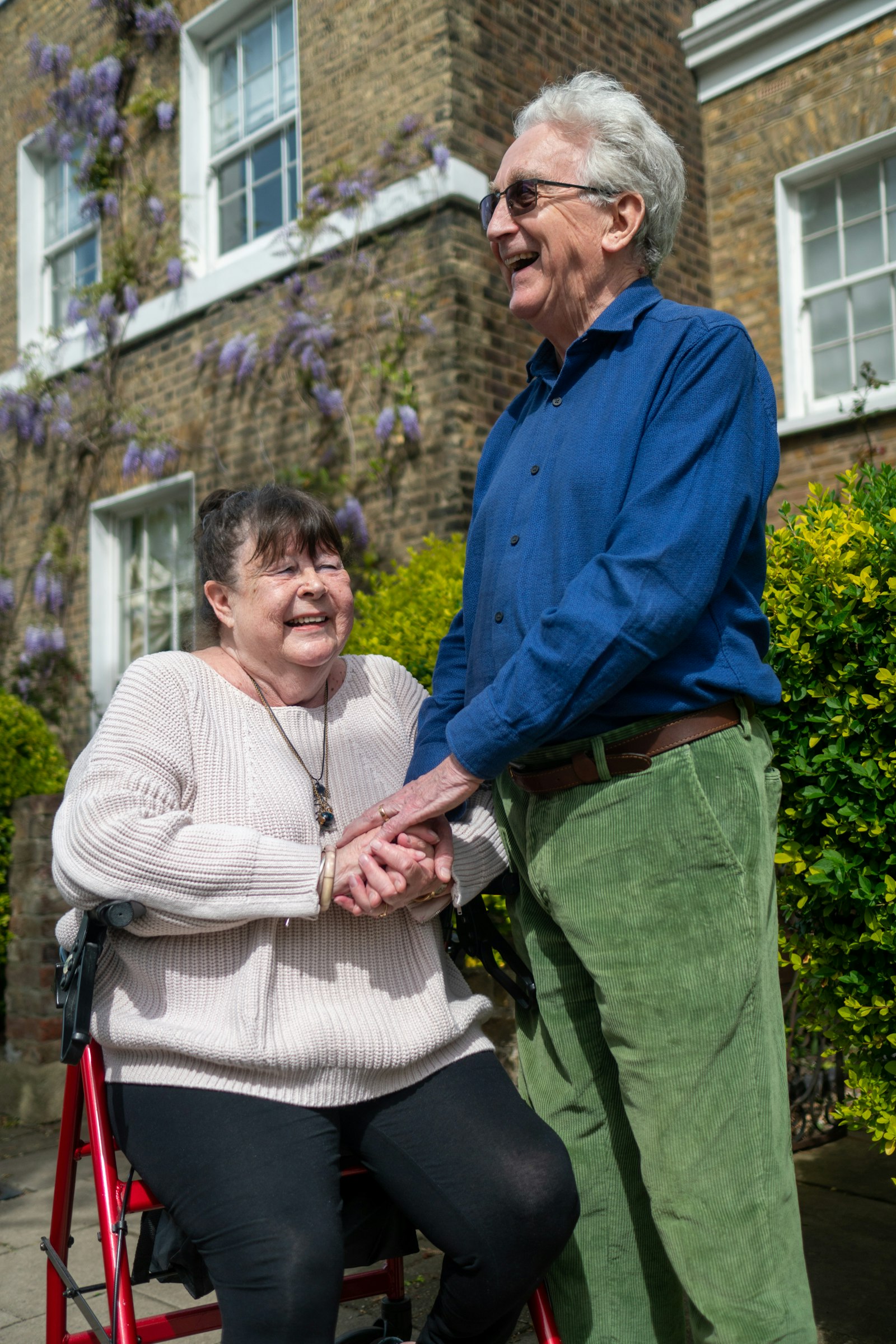 A family caregiver sharing a joyful outdoor moment with a senior loved one